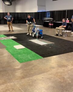Line painting contractor using a graco electric line painting machine during a line painting competition at the national pavement expo 2024 in tampa bay