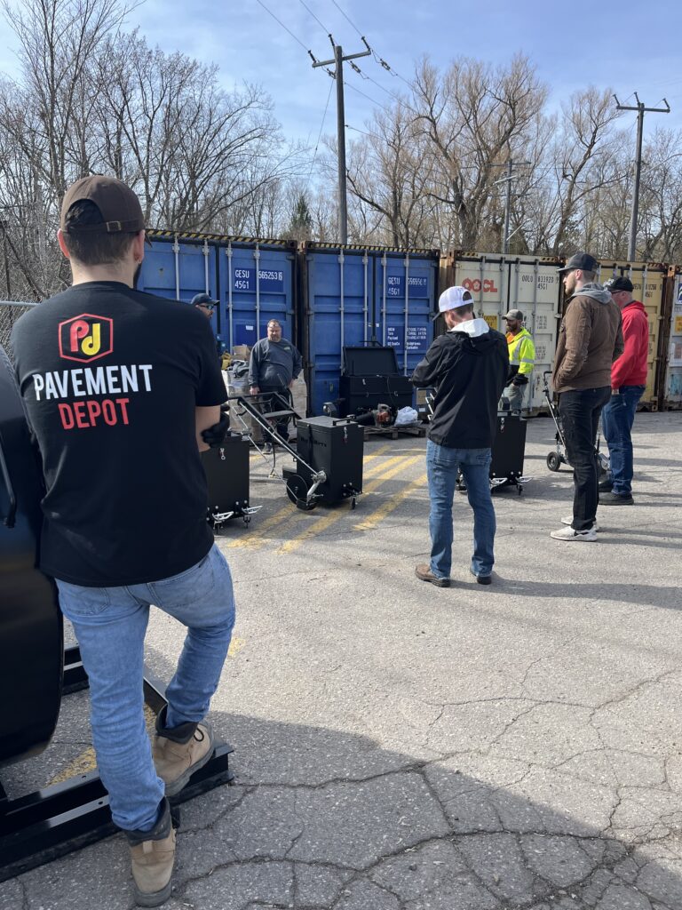 Contractors getting hands on training on how to Seal Cracked Asphalt at Pavement Depot