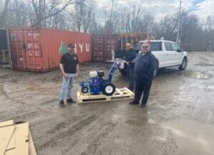 Adam from Pavement Depot and a customer who has just purchased a Graco Grindlazer standing in the Pavement Depot parking lot