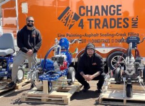 Company change 4 trades at pavement depot canada posing in front of the new Titan and Graco Line striping equipment