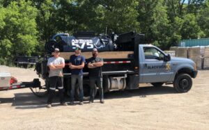 Repeat customers Blackworx gathered around their new RynoWorx Airboss 575 Asphalt Sealing Machine at Pavement Depot